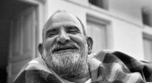 Laughing Neem Karoli Baba in black and white