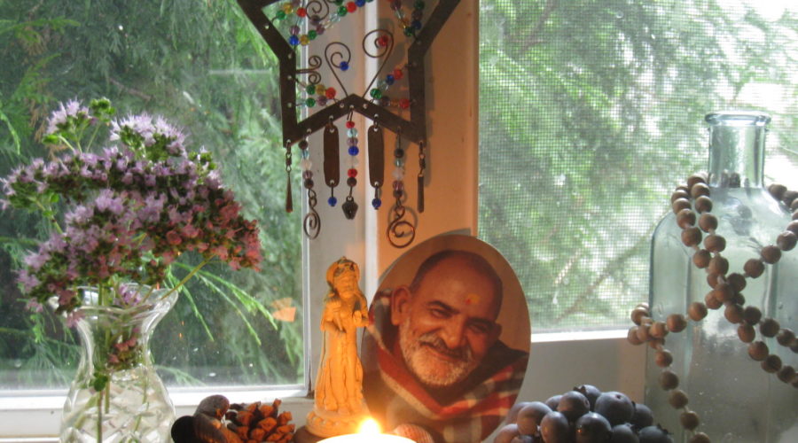 Windowsill altar with candle, berries, and Maharaji