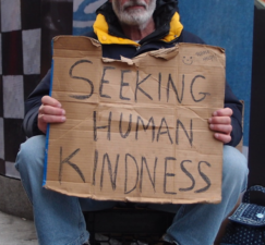 man with homeless sign