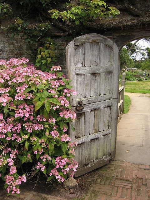 Open gate outside a spring garden