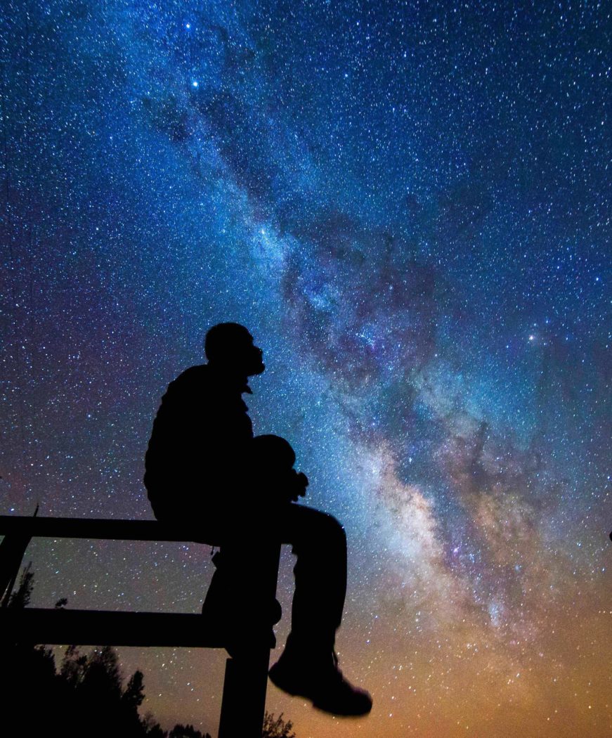 silhouette of man gazing at stars
