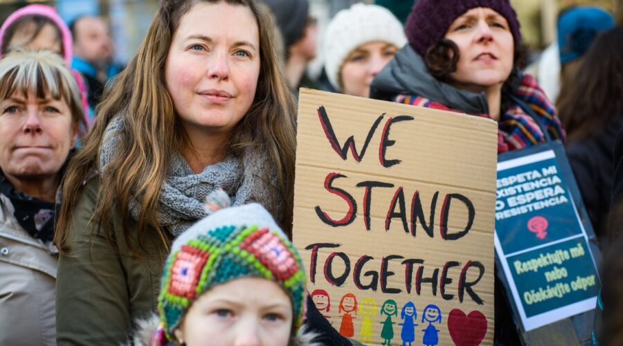 Peaceful protesters with a sign, "we stand together."