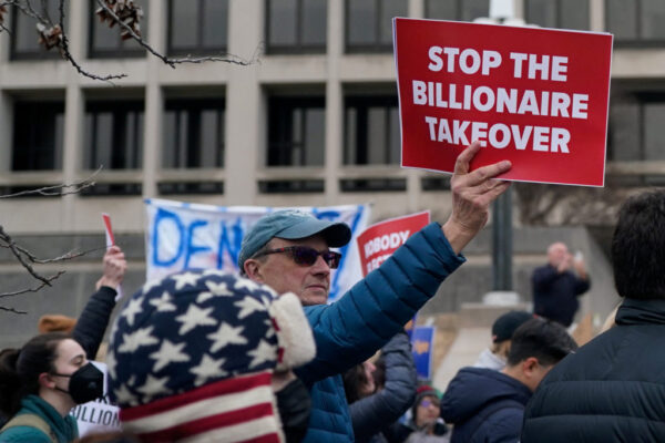 A protester holding a sign at a rally
