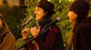 Kat Macmillan at the microphone, laughing. 